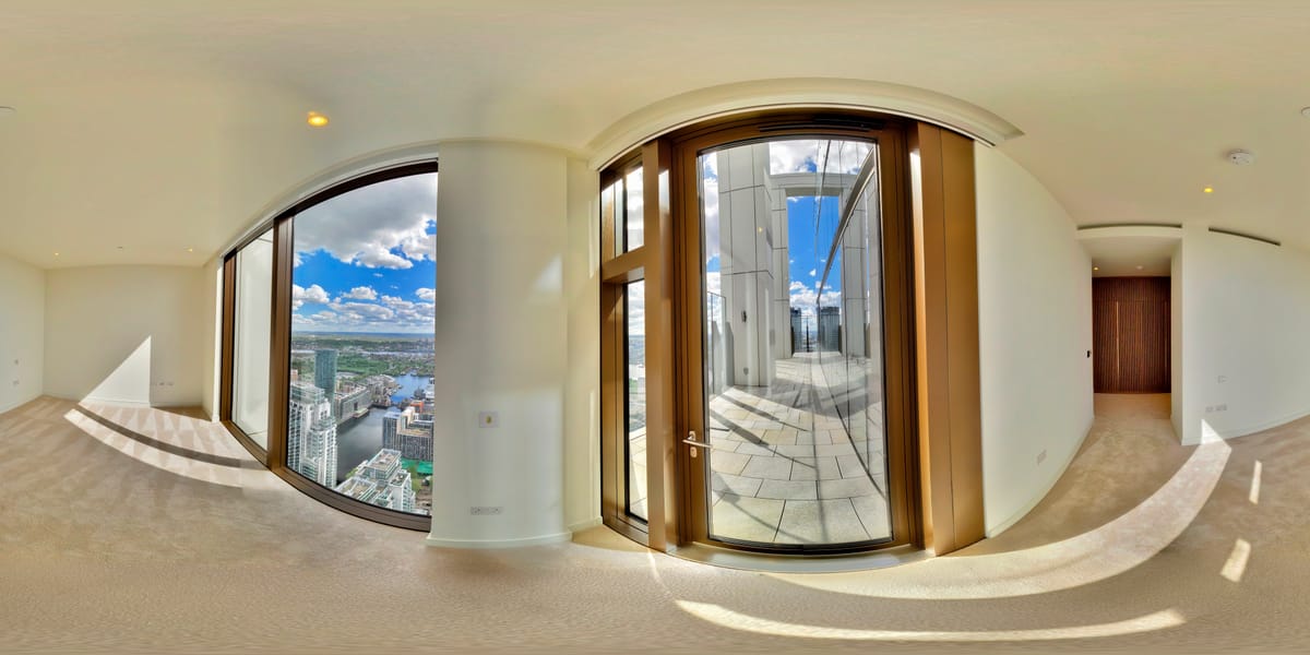 Principal bedroom with curved floor-to-ceiling windows and panoramic views of the Canary Wharf skyline