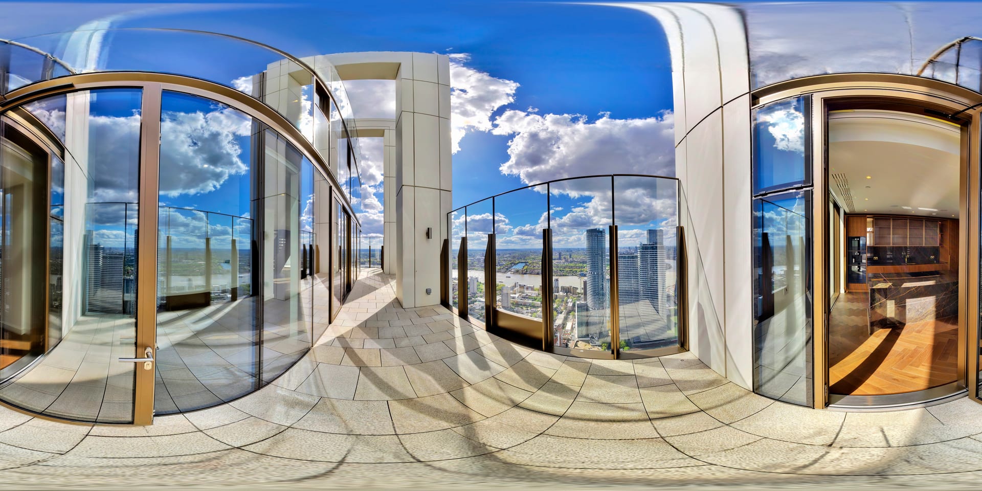 Terrace with curved glass balustrade framing a complete panorama of the Canary Wharf skyline