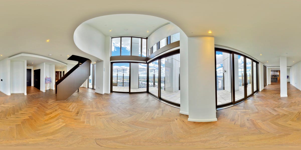 Bright open plan interior with full-height glazing flooding the room with natural light